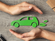 two hands holding a green car